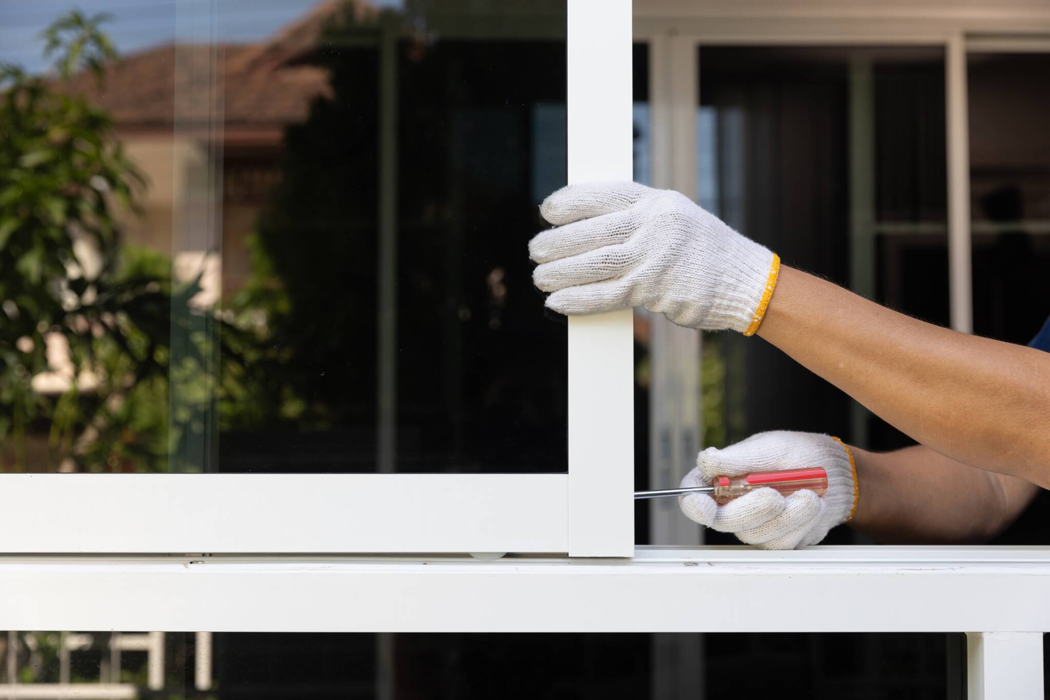 Handyman repairing the sliding window